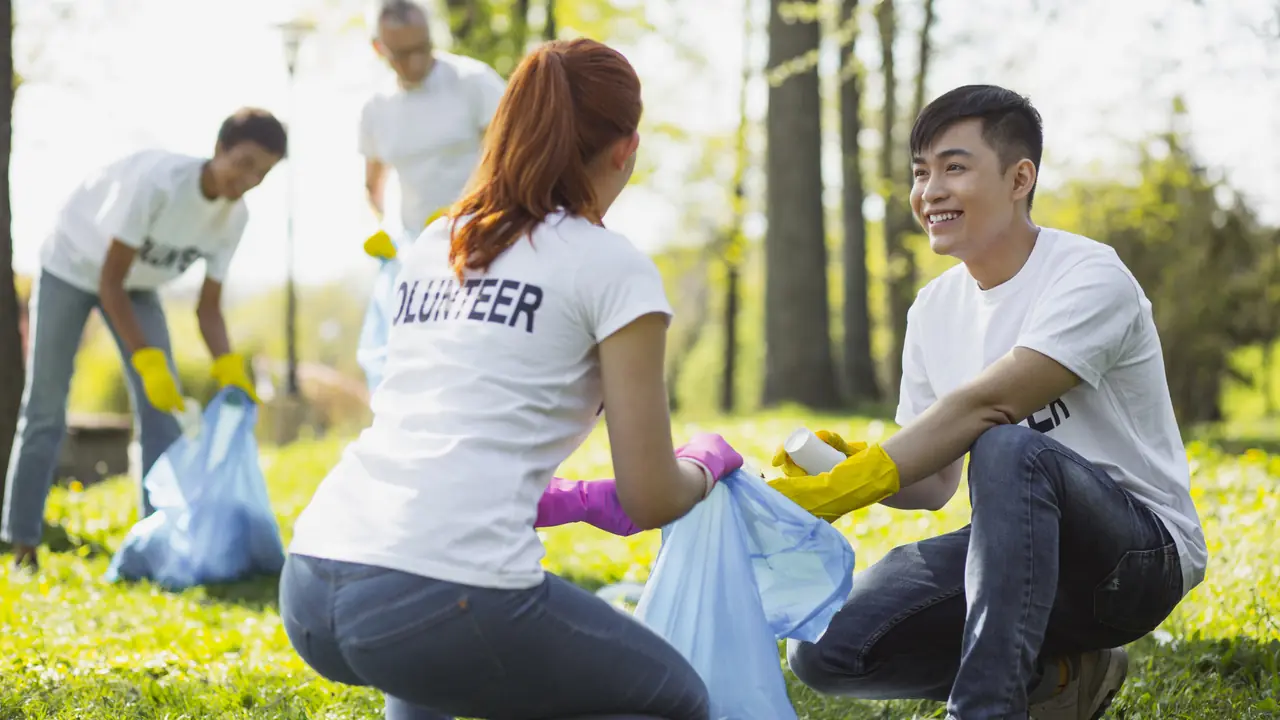 Volunteers cleaning up a park together